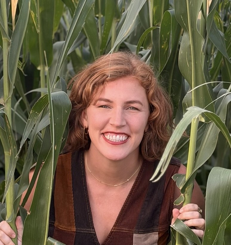Kristin Scholten, founder of OpenFields, standing in a cornfield